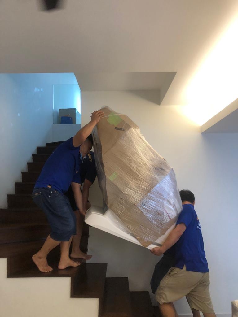 2 men carrying a heavy object during house moving